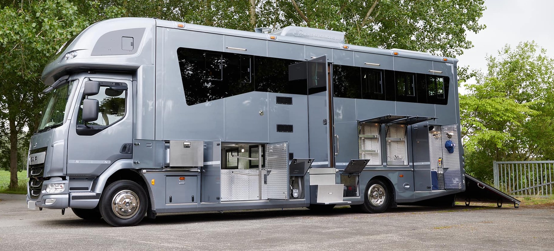 Three-horse horsebox, side on, with tack lockers open and the ramp lowered